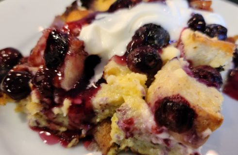 Close up view of blueberry cobbler on white plate