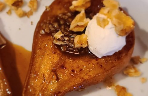 Close up view of baked pears on a white plate