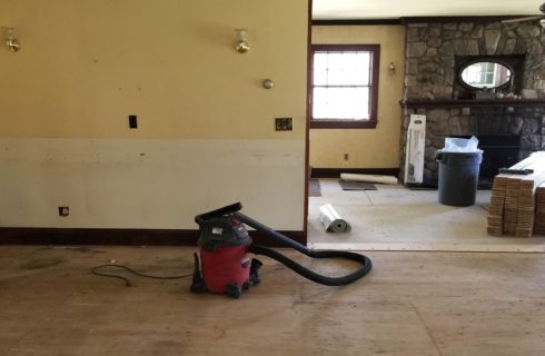 Two rooms with only subfloors and repaired drywall ready for renovations