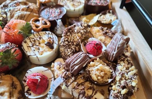 Large charcuterie board filled with desserts and fruit